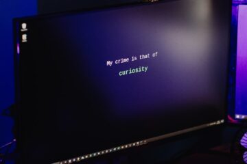 Crop hacker typing on computer keyboard while hacking system